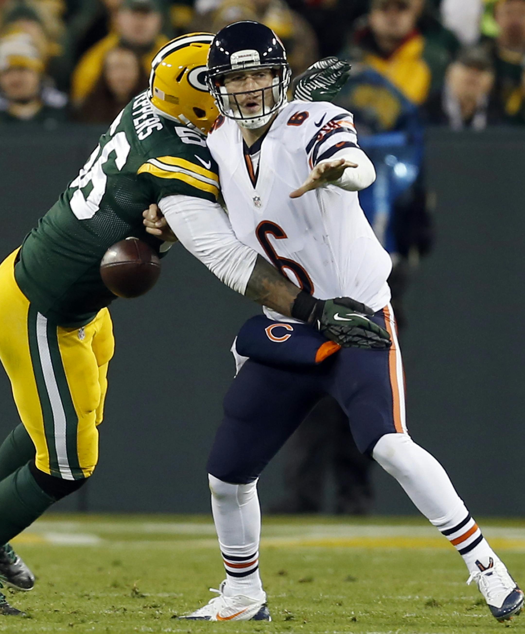 Green Bay Packers outside linebacker Julius Peppers (56) trips the ball as he tackles Chicago Bears quarterback Jay Cutler (6) during the first half of an NFL football game Sunday, Nov. 9, 2014, in Green Bay, Wis. (AP Photo/Mike Roemer)
