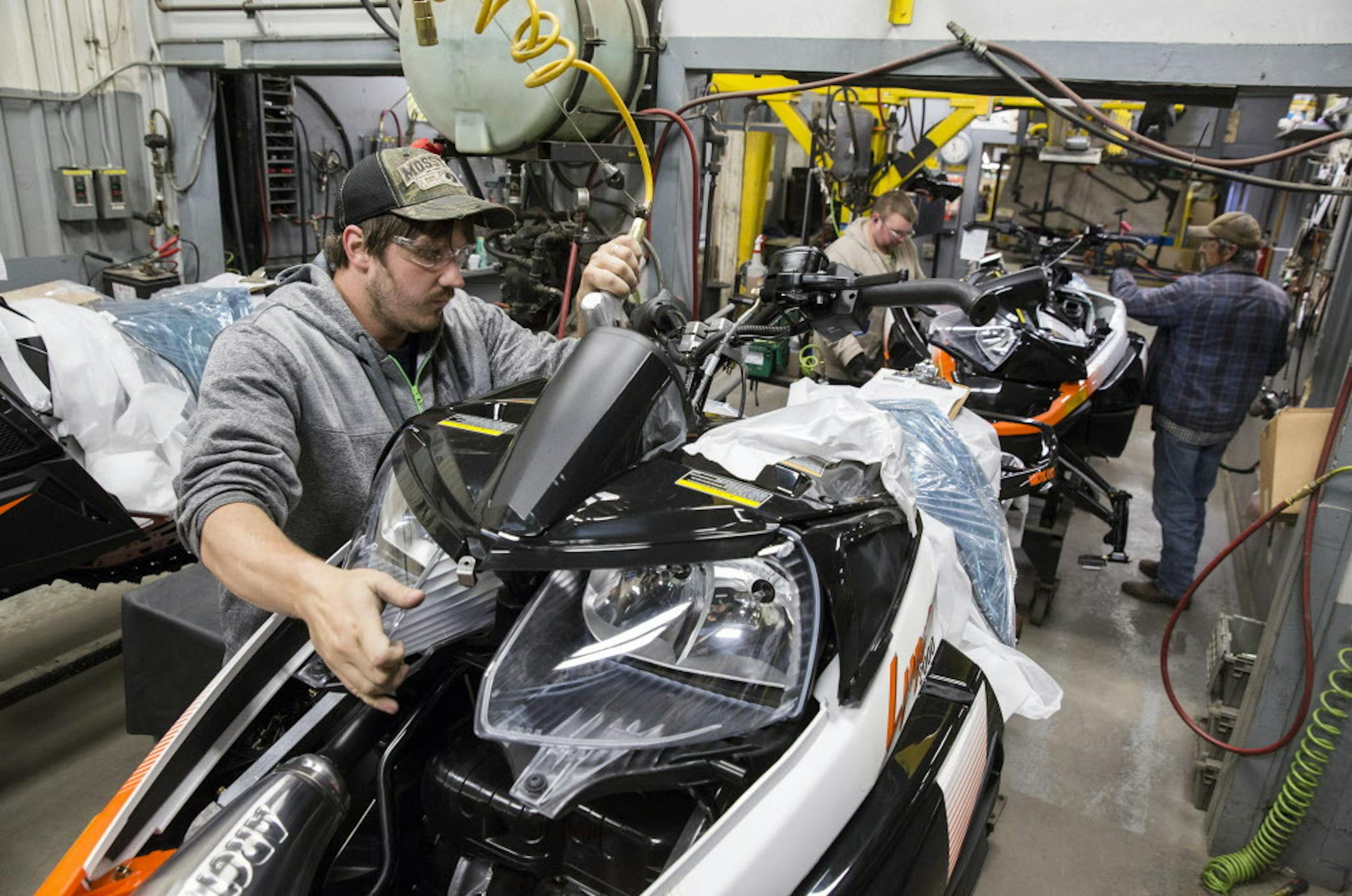 A worker puts the finishing touches on a 2016 Lynx 2000 snowmobile before it is boxed up for shipping at the Arctic Cat factory in Thief River Falls on Wednesday, September 30, 2015. ] LEILA NAVIDI leila.navidi@startribune.com / BACKGROUND INFORMATION: Arctic Cat management did not allow the photographer to get any names of the workers.
