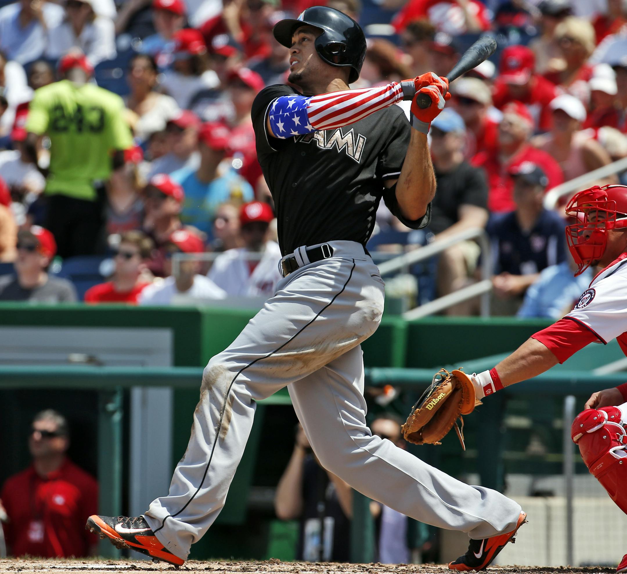Miami Marlins' Giancarlo Stanton, watches his two-run homer during the third inning of a baseball game against the Washington Nationals at Nationals Park Monday, May 26, 2014, in Washington. (AP Photo/Alex Brandon) ORG XMIT: NAT115