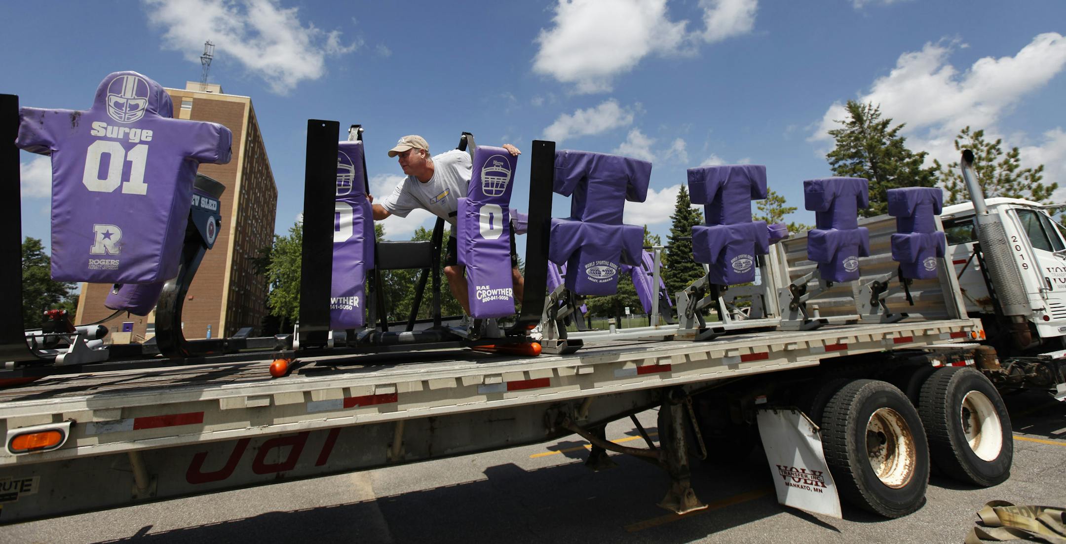 Vikings employee Jerry Reite began unloading blocking sleds Monday at the team's training camp headquarters in Mankato.