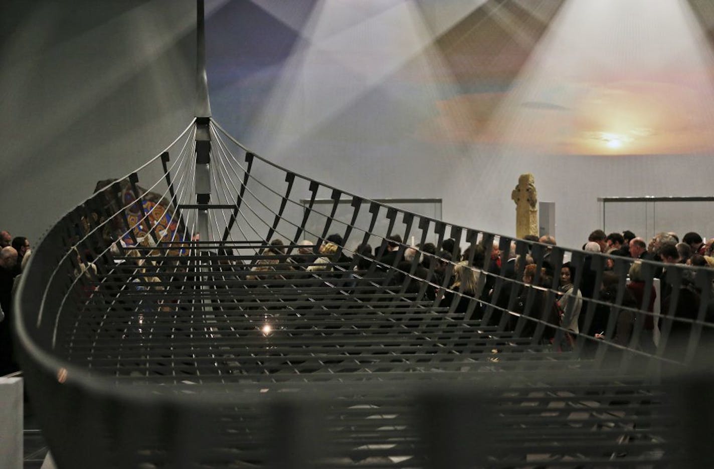 Visitors wander around a new exhibition entitled 'Vikings: Life and Legend' at the British Museum in central London, Tuesday, March 4, 2014. The centerpiece of the show is the biggest Viking ship ever found, which was unearthed on the banks of a Danish fjord in 1997. It is 37 meters (120 feet) long and had 40 pairs of oars. Only about 20 percent of the ship's timbers remain.