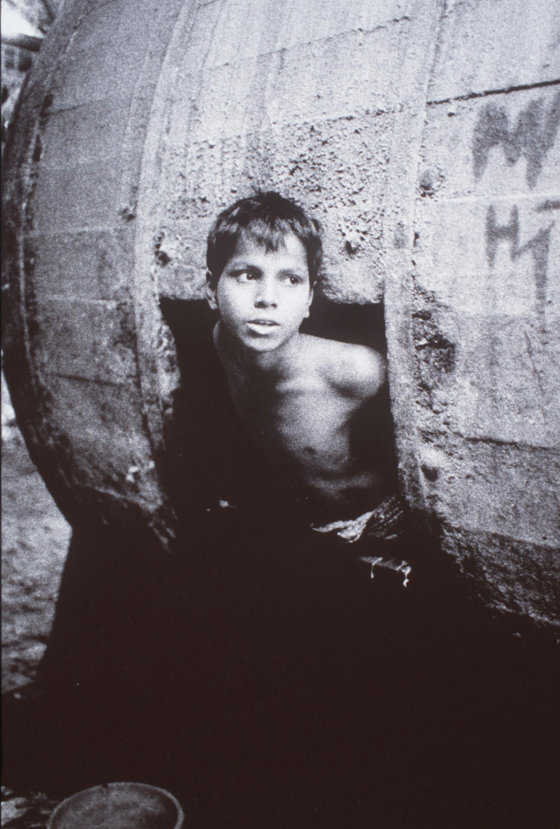 Leather worker, Dhaka Bangladesh 1993 // A child emerged from a barrel in the leather factory where he works in Dhaka, Bangladesh, in 1993. / Photo by David Parker, a Minneapolis physician. ORG XMIT: MIN2013073110531422