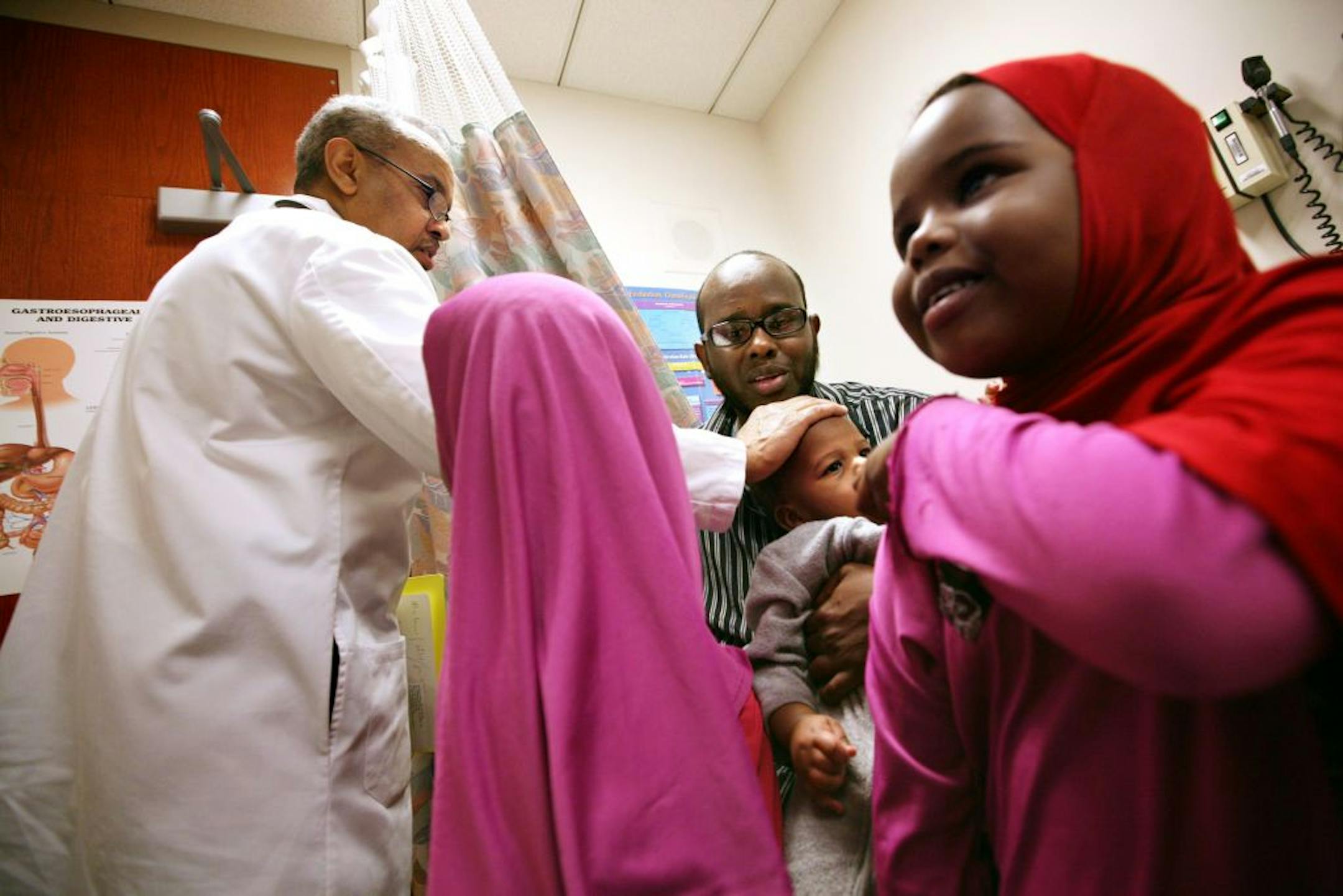 Dr. Mohamed Hassan greeted 11-month-old Salman Husen after an appointment with Salman's mother at the University of Minnesota Medical Center.