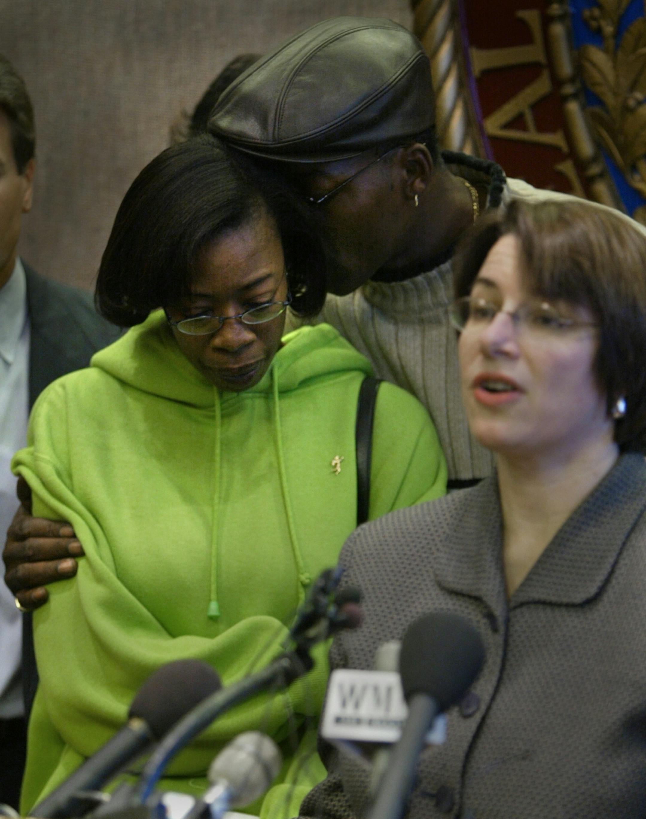 Linda Longino, mother to Tyesha Edwards, and Edwards' step-father, Leonard Winborn, consoled each other as Hennepin County Attorney Amy Klobuchar announced the names of those arrested in the shooting death of Edwards in 2002.