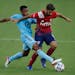 FC Dallas midfielder Facundo Quignon, right, tries to maintain ball control as Minnesota United midfielder Jacon Hayes defends during the first half o