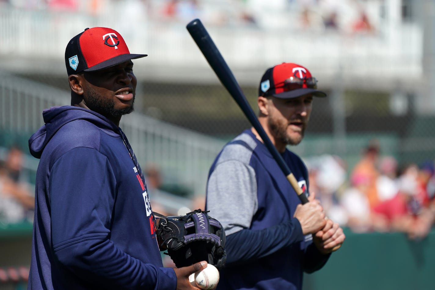 Minnesota Twins third baseman Miguel Sano (22), who sat out of fielding drills due to a cut on his right leg, fed balls to manager Rocco Baldelli during fielding drills Monday.] ANTHONY SOUFFLE • anthony.souffle@startribune.com