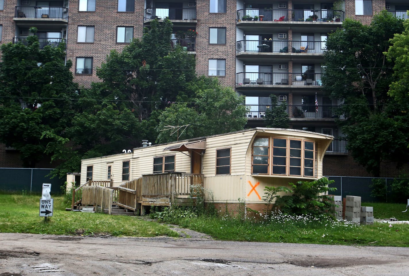 A home is marked with an X for demolition in Lowry Grove, a manufactured home park in St. Anthony.