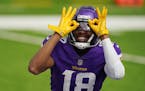 Minnesota Vikings wide receiver Justin Jefferson (18) celebrated after he scored his first NFL touchdown in the third quarter.