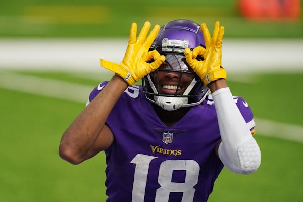 Minnesota Vikings wide receiver Justin Jefferson (18) celebrated after he scored his first NFL touchdown in the third quarter.