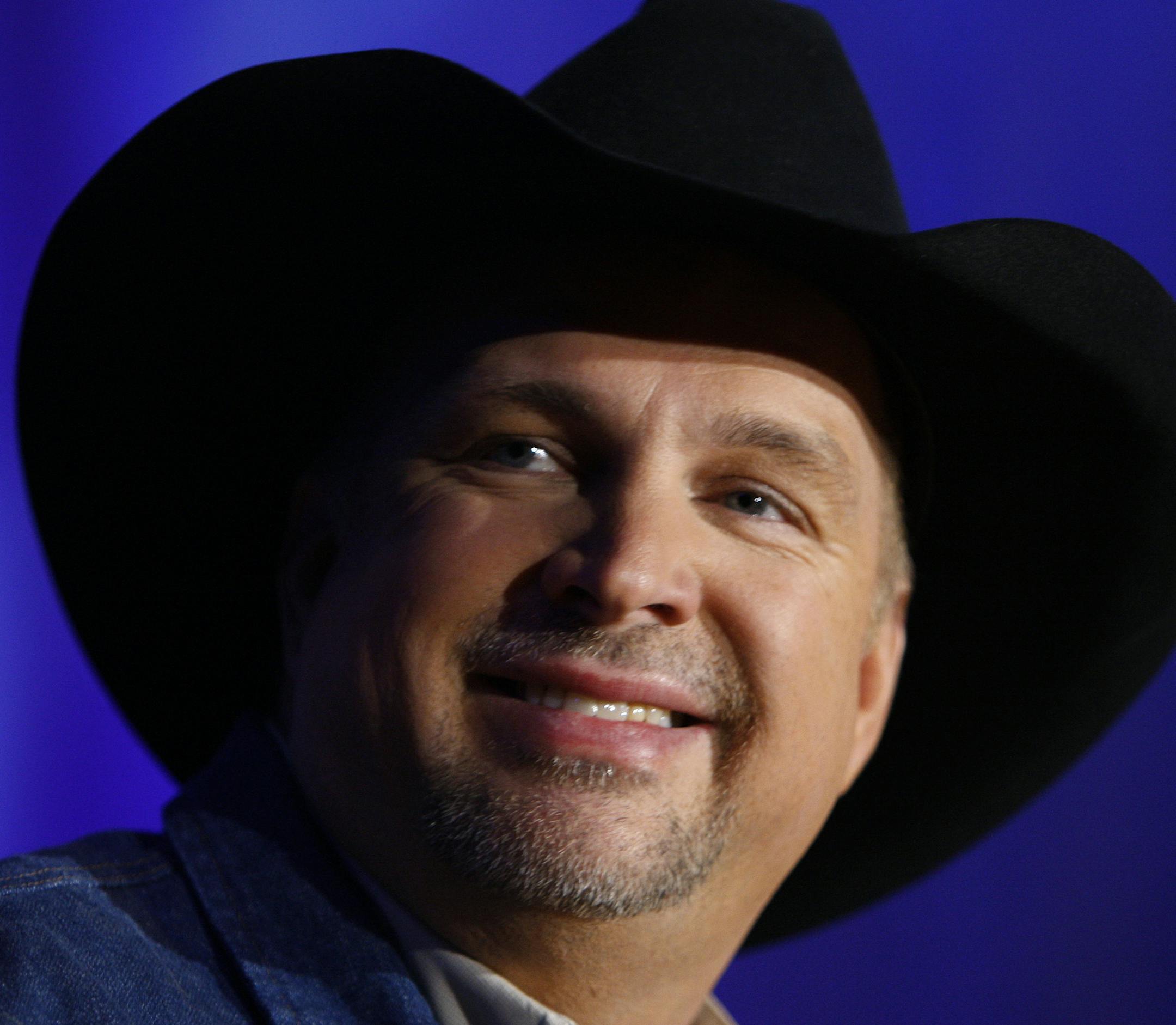 FILE - In this Oct. 15, 2009 file photo, country music star Garth Brooks appears at a news conference in Nashville, Tenn., to announce that he's coming out of retirement. A multigenerational crowd sang along with country music's biggest star as he kicked off the first of nine sold-out flood relief benefit concerts Thursday night Dec. 16, 2010 in Nashville, Tenn. (AP Photo/Mark Humphrey, File) ORG XMIT: MIN2014110519415778