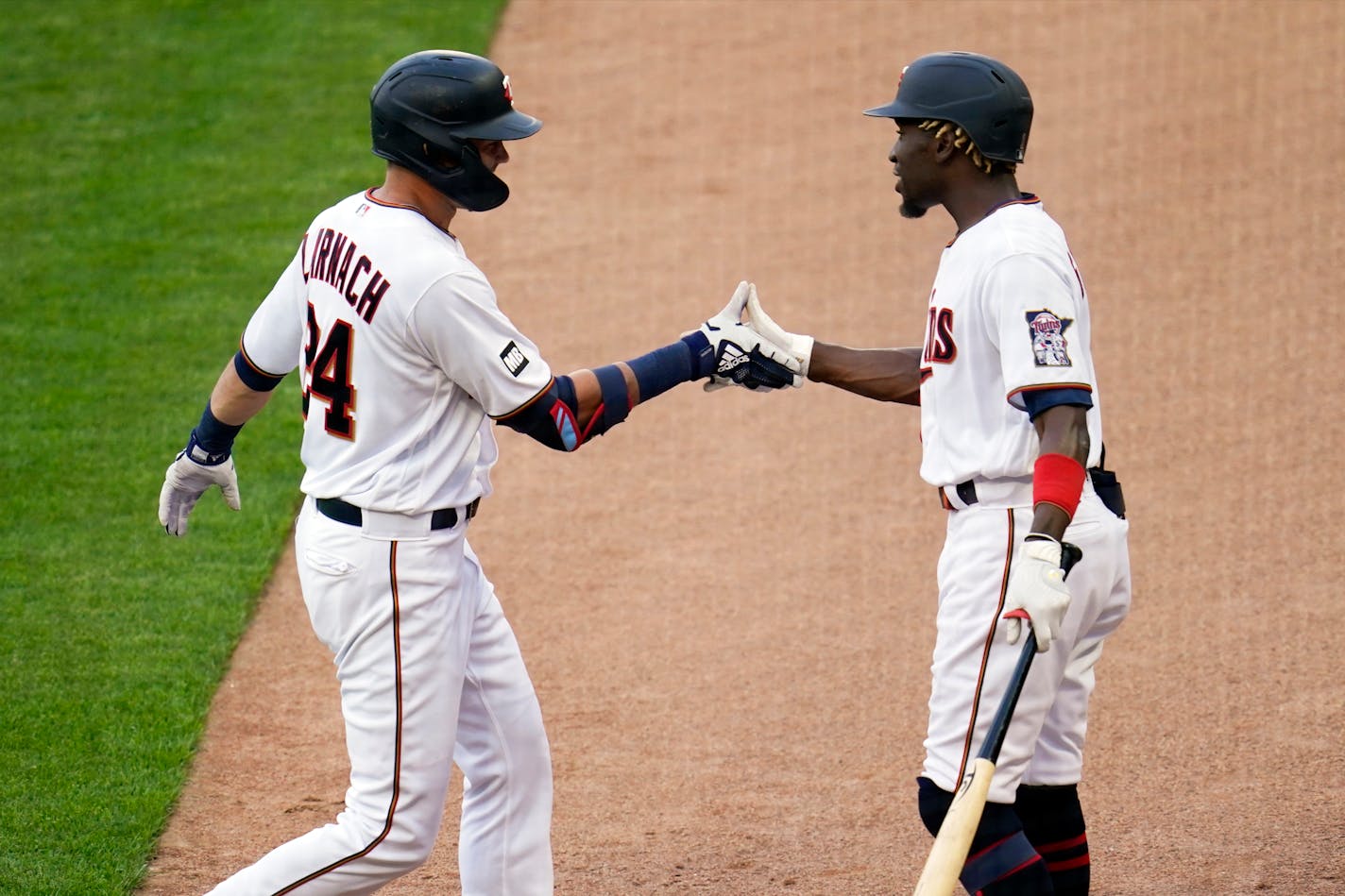 Minnesota Twins' Trevor Larnach, left is congratulated by Nick Gordon following his solo home run off Baltimore Orioles pitcher John Means in the third inning of a baseball game, Monday, May 24, 2021, in Minneapolis. (AP Photo/Jim Mone)