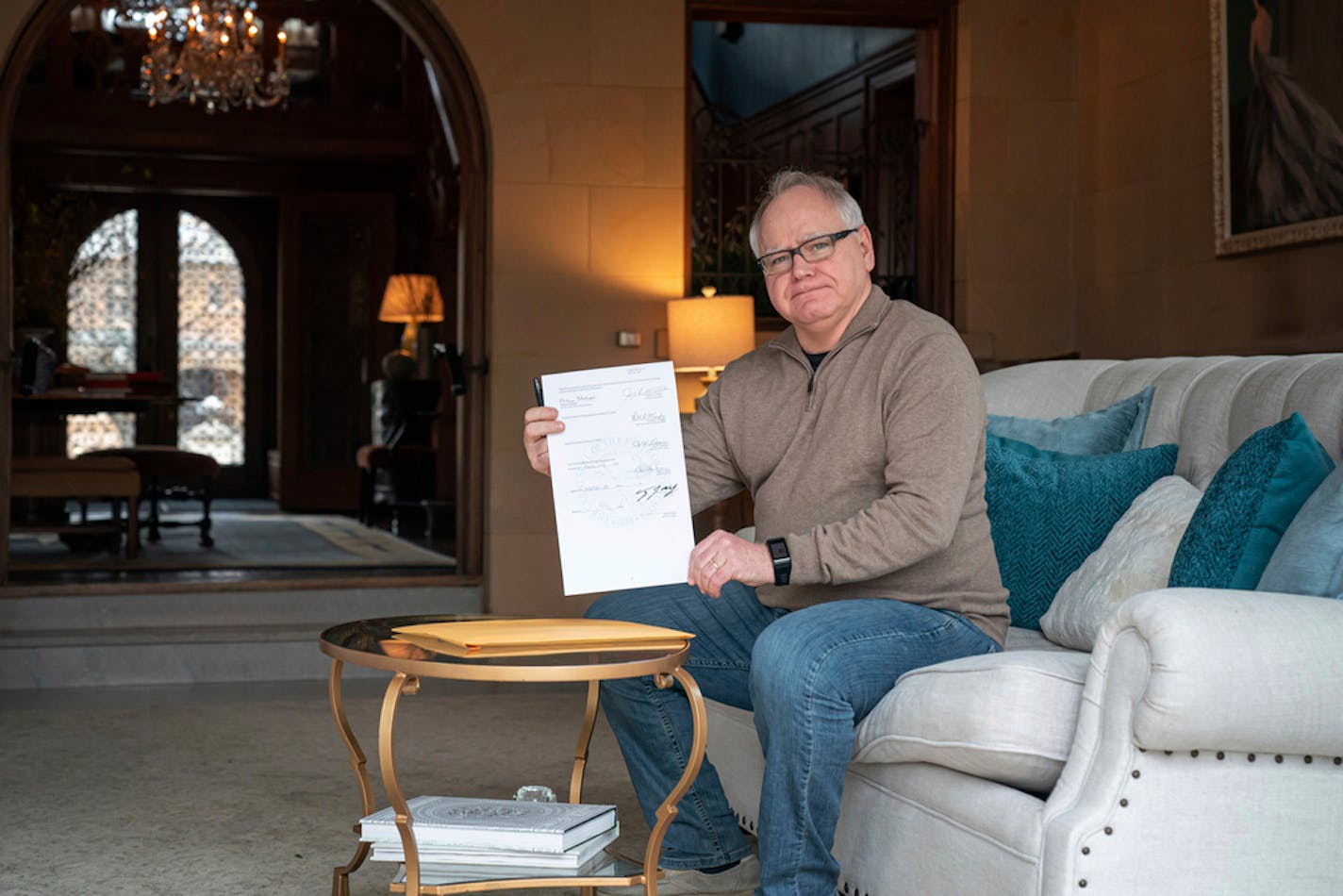 Minnesota Gov. Tim Walz signed a bill March 28, 2020, allocating $330 million in COVID-19 aid at the Governor's Residence in St. Paul.