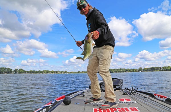 Seth Feider with a plump largemouth bass caught while practice fishing on Lake Minnetonka in advance of the big Bassmaster tournament on Lake Mille La