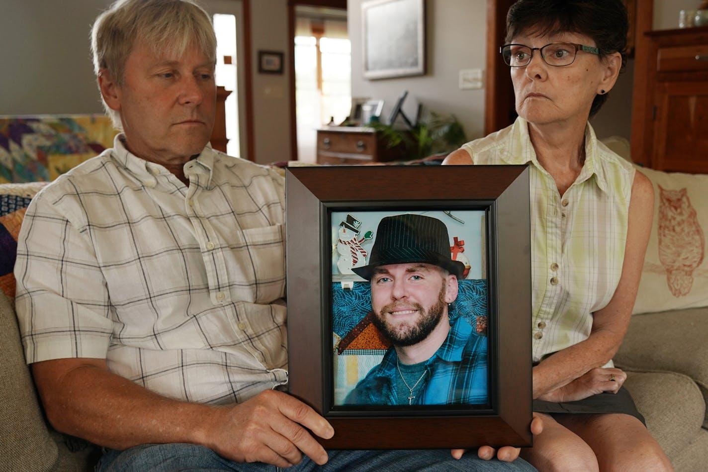 Matthew Klaus' parents John and Denise Klaus held a portrait of their deceased son at their home in Oronoco. ] ANTHONY SOUFFLE &#x2022; anthony.souffle@startribune.com John and Denise Klaus posed for a portrait Tuesday, July 30, 2019 at their home in Oronoco, Minn. Their son Matthew Klaus, who died of a heroin overdose in March, had been working with police as an informant to catch a heroin dealer.