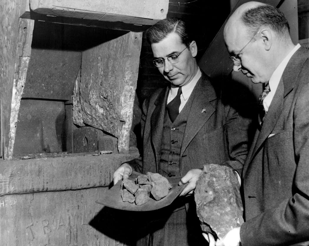 Iron Range Resources and Rehabilitation Commissioner Robert E. Wilson and University of Minnesota Metallurgist H.H. Wade hold chunks of taconite ore in 1945 during tests at the University.