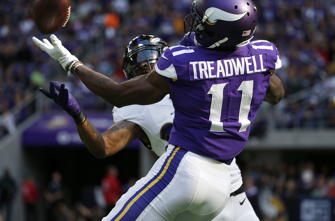 Baltimore Ravens cornerback Brandon Carr, rear, intercepts a pass intended for Minnesota Vikings wide receiver Laquon Treadwell (11) during the first half of an NFL football game, Sunday, Oct. 22, 2017, in Minneapolis. (AP Photo/Bruce Kluckhohn)