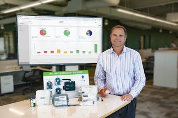 CEO Ron Konezny of Digi International with several “Internet of Things” communications devices that link industrial equipment to the internet for 