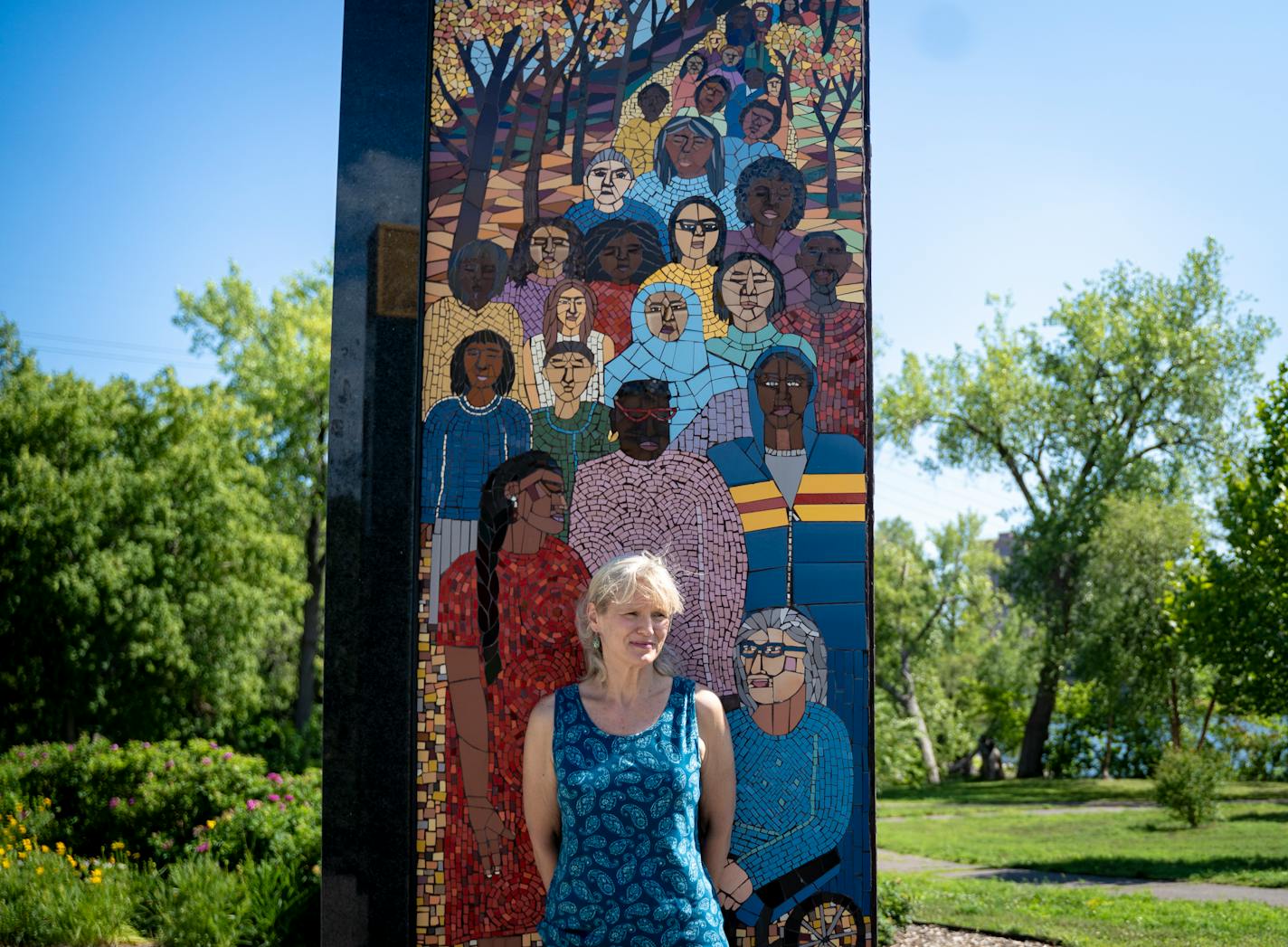 Sheila Biernat, wearing teal to represent the color of sexual assault awareness, stands in front of the Memorial to Survivors of Sexual Violence in Boom Island Park in Minneapolis, Minn. on Friday, Aug. 11, 2023, the day after Robert Allen Delong, who raped a close relative of Biernat's at gunpoint, was sentenced to 30 years in prison. The memorial, made by mosaic artist Lori Greene, is the first permanent memorial for sexual assault survivors in the nation and stands in the same park where the victim was raped 16 years prior. Biernat testified in the place of her relative and says the family is relieved that justice was finally served. ] Angelina Katsanis • angelina.katsanis@startribune.com