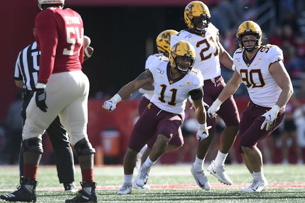 Gophers defensive back Antoine Winfield Jr. (11) celebrated after intercepting a pass thrown by Rutgers quarterback Johnny Langan (17) in the first qu