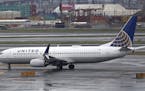 The New York City skyline gives backdrop to a United Airlines airplane taxing at Newark Liberty International Airport, Wednesday, April 12, 2017, in N