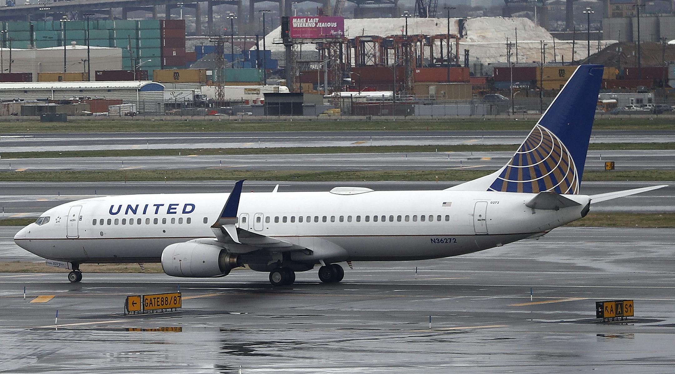 The New York City skyline gives backdrop to a United Airlines airplane taxing at Newark Liberty International Airport, Wednesday, April 12, 2017, in Newark, N.J. (AP Photo/Julio Cortez) ORG XMIT: MIN2017041314332656