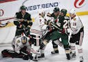 Wild and Blackhawks players tussled in the third period during Chicago's 2-0 victory at Xcel Energy Center on Saturday.