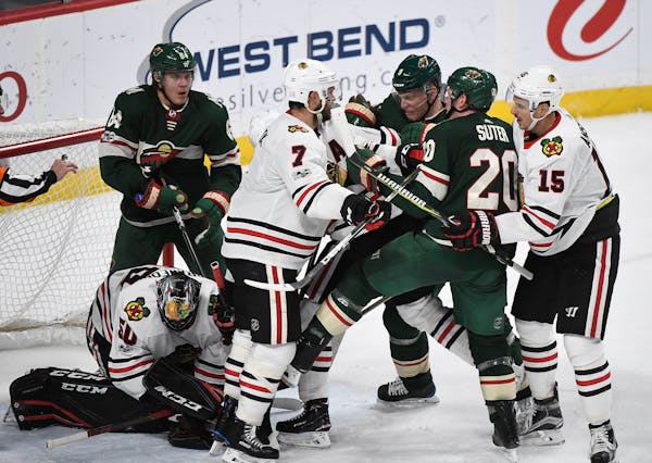 Wild and Blackhawks players tussled in the third period during Chicago's 2-0 victory at Xcel Energy Center on Saturday.