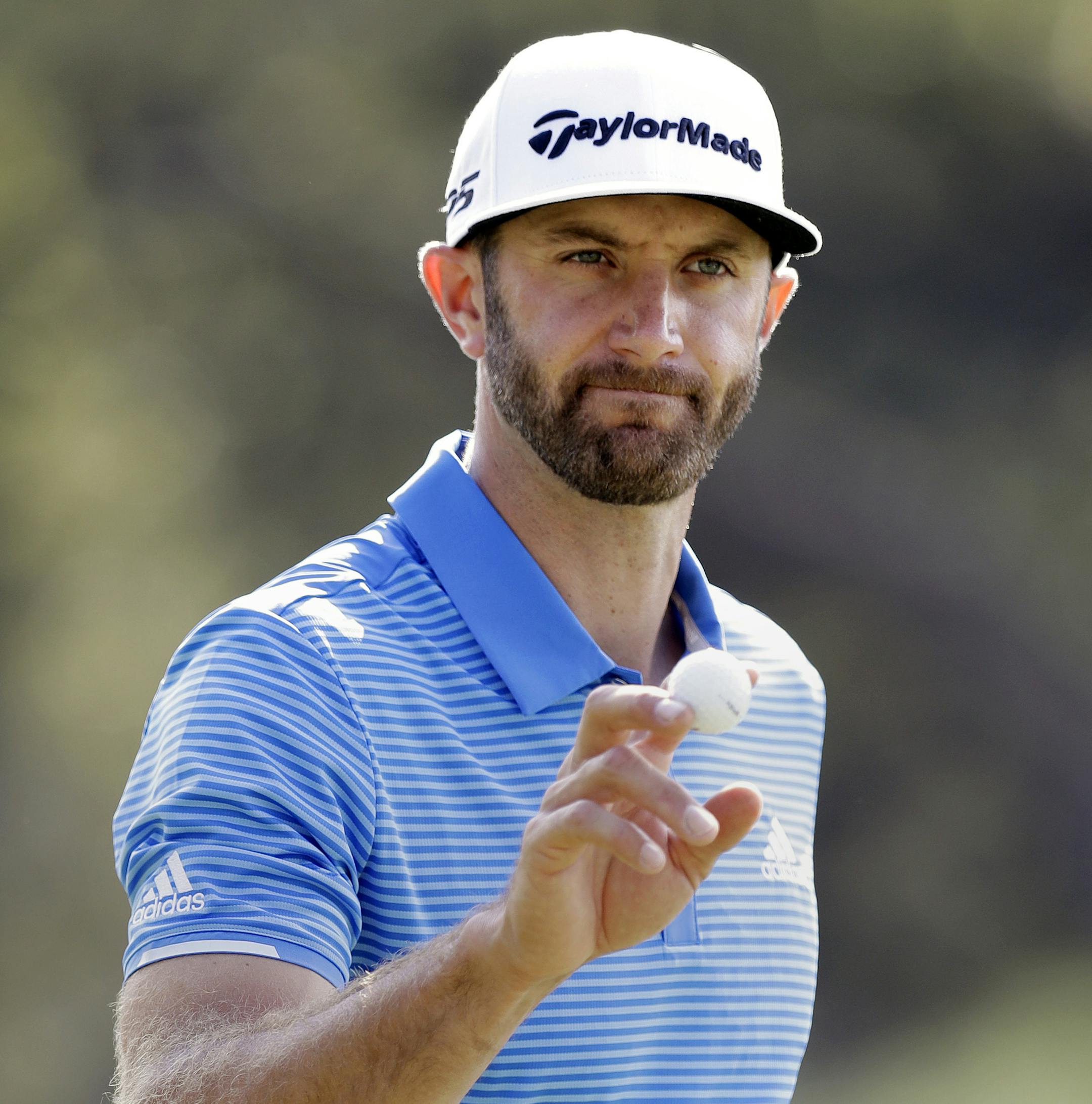 FILE - In this March 26, 2017, file photo, Dustin Johnson waves to the gallery after a birdie putt on the sixth hole during semifinal play at the Dell Technologies Match Play golf tournament at Austin County Club in Austin, Texas. (AP Photo/Eric Gay, File)