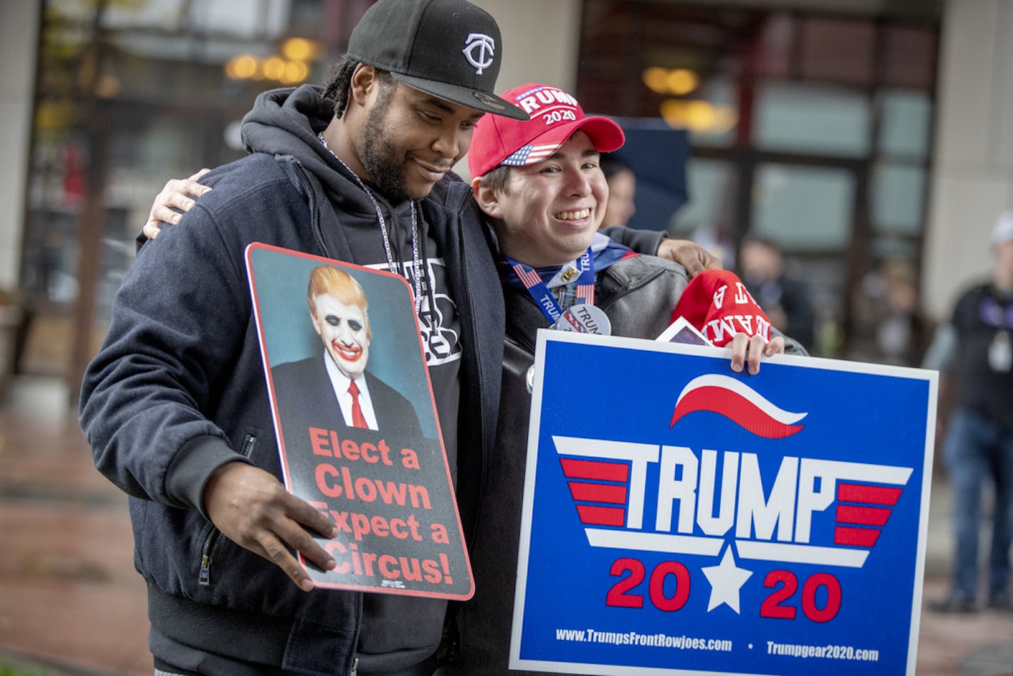 Anti-Trump Willy Jenkins, left, and Trump supporter Chris Windego, right, gave each other a hug as they waited outside the Target Center in preparation for President Trump's visit, Thursday, October 10, 2019 in Minneapolis, MN. ] ELIZABETH FLORES &#x2022; liz.flores@startribune.com