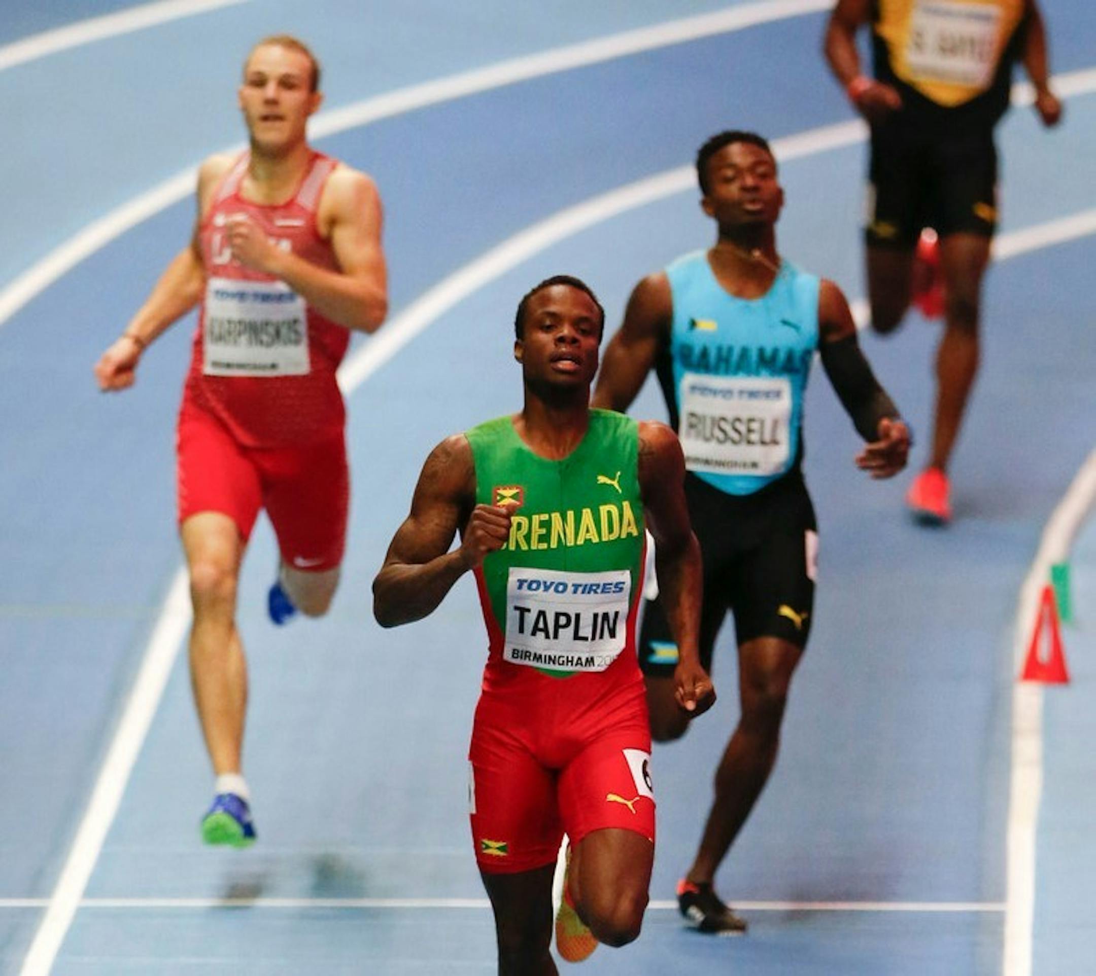 Grenada's Bralon Taplin, center front, leads in a men's 400 meter heat at the World Athletics Indoor Championships in Birmingham, Britain, Friday, but all runners in the heat were disqualified.
