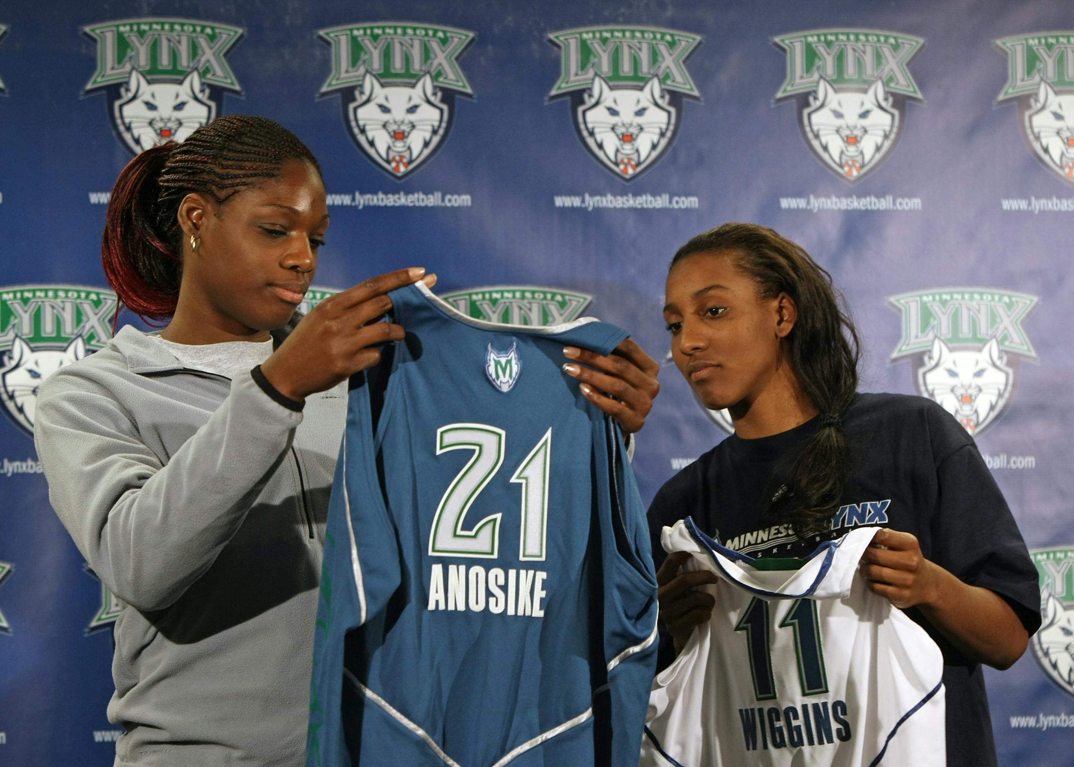 (left to right) Minnesota Lynx top draft choices Nicky Anosike of Tennesse and Candice Wiggins of Stanford looked at their new jerseys at the end of a press conference at Target Center announcing their signing with the team.