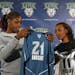 (left to right) Minnesota Lynx top draft choices Nicky Anosike of Tennesse and Candice Wiggins of Stanford looked at their new jerseys at the end of a