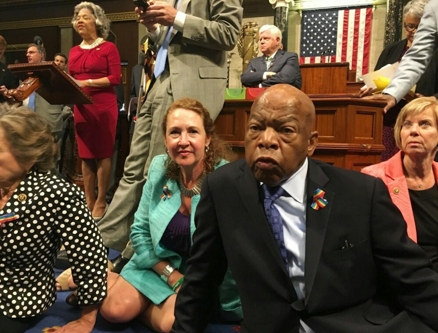 This photo provided by Rep. Chillie Pingree,D-Maine, shows Democrat members of Congress, including Rep. John Lewis, D-Ga., center, and Rep. Elizabeth Esty, D-Conn. as they participate in sit-down protest seeking a a vote on gun control measures, Wednesday, June 22, 2016, on the floor of the House on Capitol Hill in Washington.