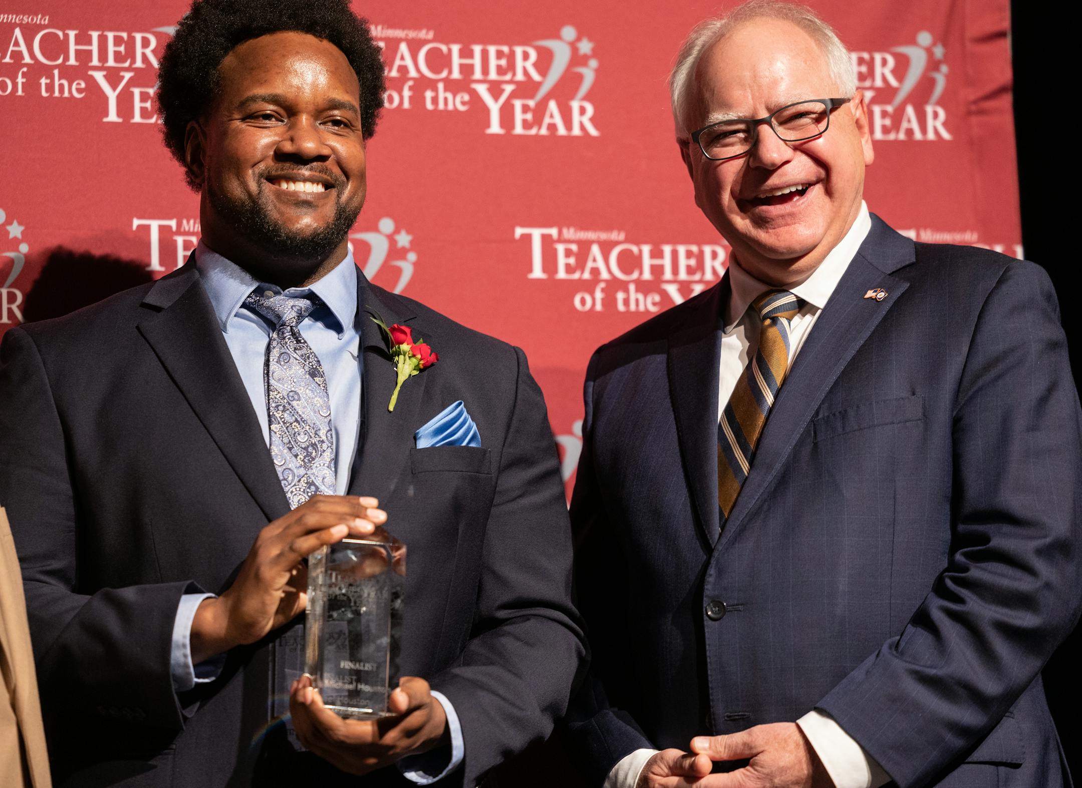 Governor Tim Walz poses for a photo with Michael Houston, a mathematics teacher at Harding High School, who was named the 2023 Minnesota Teacher of the Year.