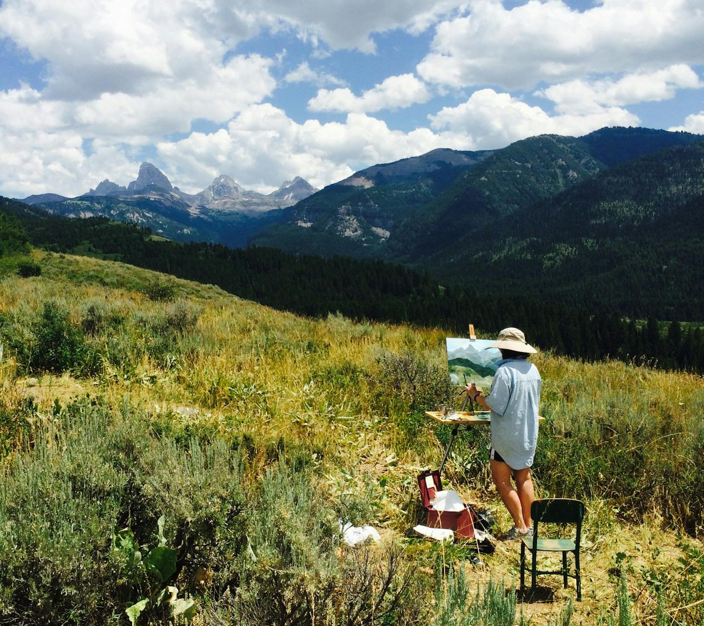 Margie Brackin painting the Grand Tetons on a trip out of Driggs , ID