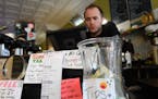 Andy Regan, a barista at Maeve's Cafe in Northeast Minneapolis, changed the music at the cafe between orders Wednesday afternoon. ] AARON LAVINSKY &#x
