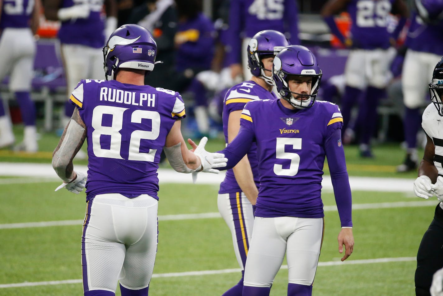 Minnesota Vikings place kicker Dan Bailey (5) reacts with teammate Kyle Rudolph after a field goal attempt during the second half of an NFL football game against the Jacksonville Jaguars, Sunday, Dec. 6, 2020, in Minneapolis. (AP Photo/Bruce Kluckhohn)