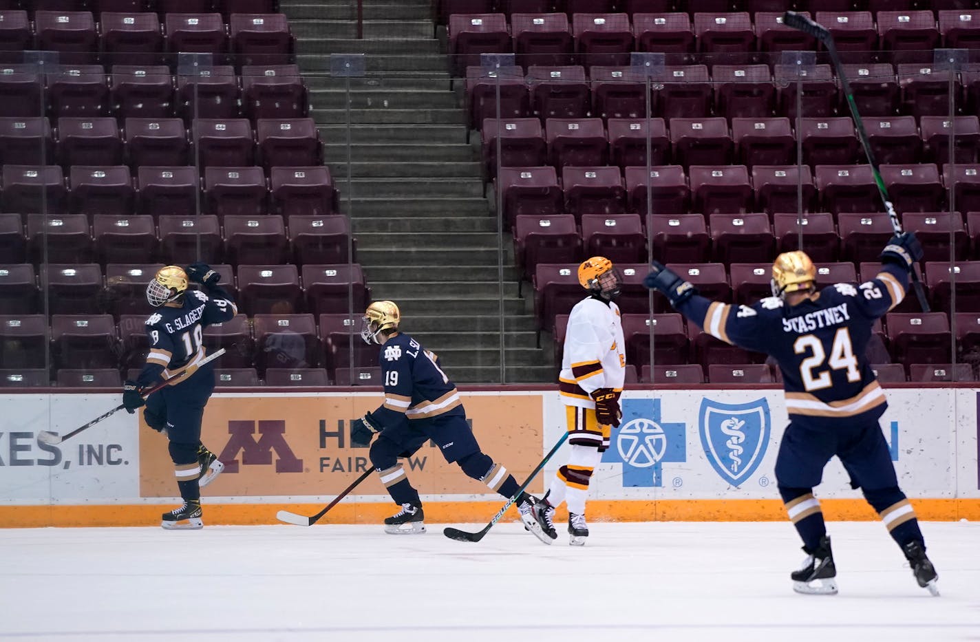 Notre Dame's Graham Slaggert (18) and Landon Slaggert (19) celebrated the game-winning goal Friday night against the Gophers. The Irish completed the sweep with a win on Saturday.