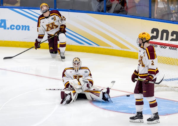 Minnesota goalie Justen Close (1) and teammates were stunned after Quinnipiac scored 10 seconds into overtime to win the men’s Frozen Four title on 