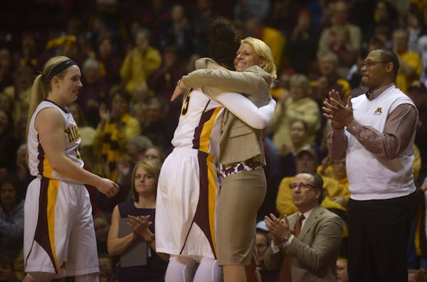 Gophers' coach Pam Borton hugs Micaella Riche after taking her out of the game for the last time at Women's Gopher basketball against Ohio State on Su