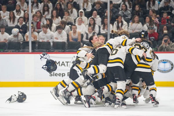 Warroad players celebrate after defeating Orono 3-1 to win the Class 1A girl's hockey championship Saturday, Feb. 25, 2023 at Xcel Energy Arena in St.