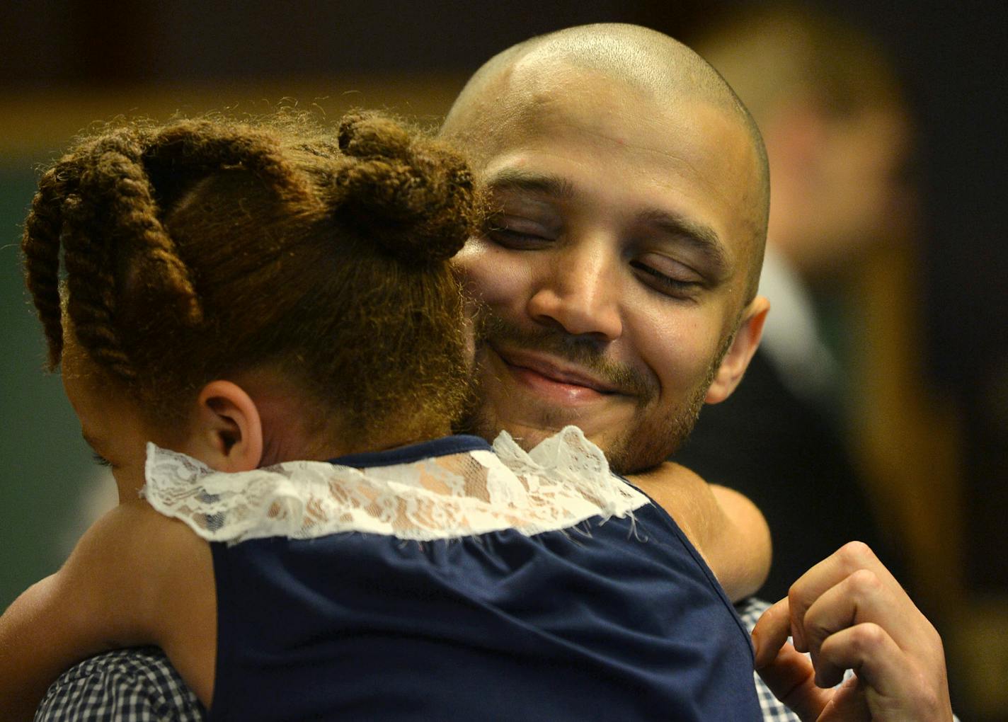 From left, Saniah King, 6, hugged her father, Veteran graduate Charles King after the Veterans graduation ceremony held in the Ramsey County District Court in St. Paul, Minn., on Thursday July 9, 2015. The Ramsey County Veterans Treatment Court held a graduation ceremony for four veterans. ] RACHEL WOOLF &#xb7; rachel.woolf@startribune.com