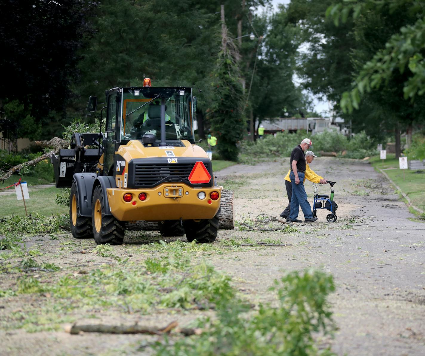 Two people walked by as a crew from the St. Paul parks and recreation department removed ash trees along Juno Avenue Thursday, Aug. 2, 2018, in St. Paul, MN.] DAVID JOLES • david.joles@startribune.com St. Paul cut down more than 10,000 trees infested with Emerald Ash Borer between 2010 and 2017, but replantings haven't kept pace with removals. Data from the city's Parks and Recreation department show that over time, EAB-related plantings have slowed while the number of removals has increased (we