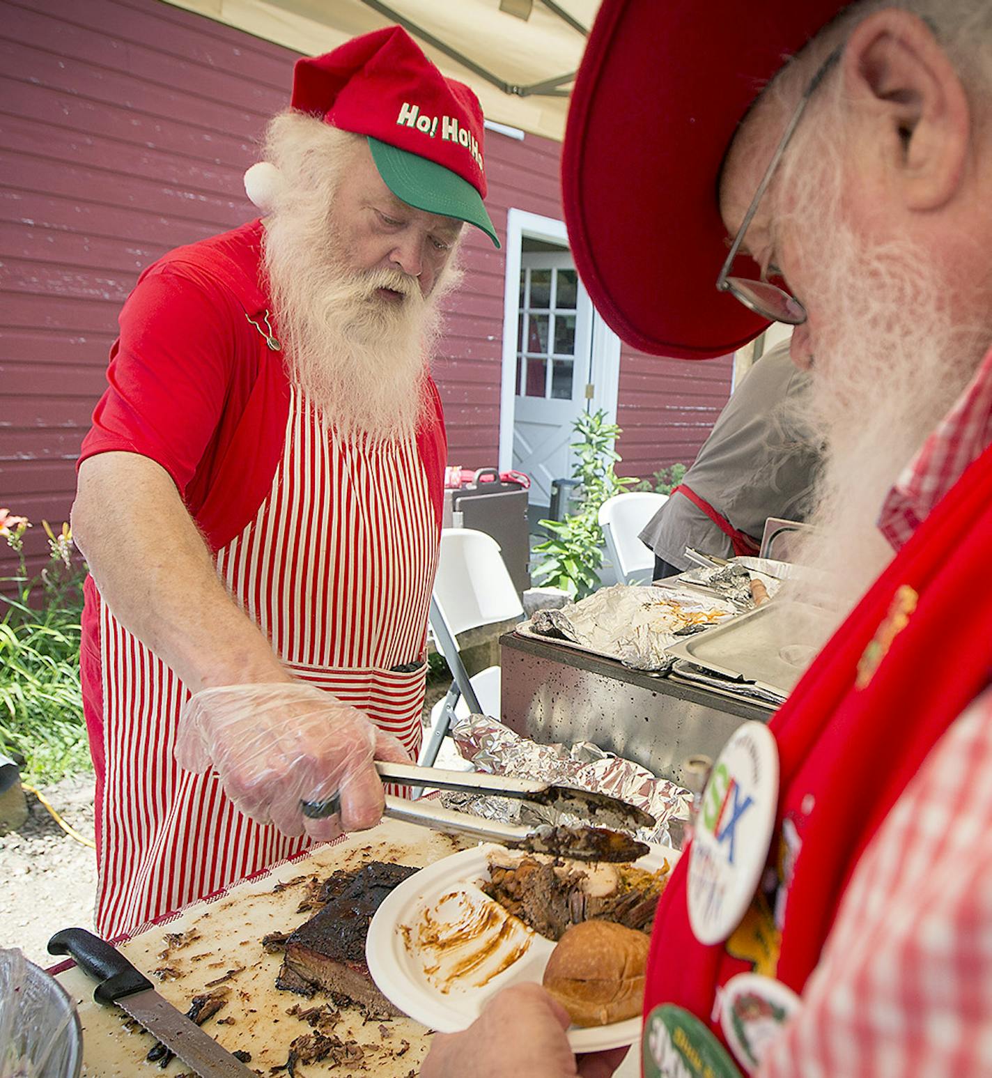 Santa Mickey Michlitsch fed members of the &#x201c;Minnesota Santas&#x201d; organization during their summer picnic at the Bruentrup Heritage Farm in Maplewood.