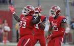 From left to right, Fresno State's Jasad Haynes, Mike Bell and Aaron Mosby celebrate a fumble against Idaho during the first half of an NCAA college f