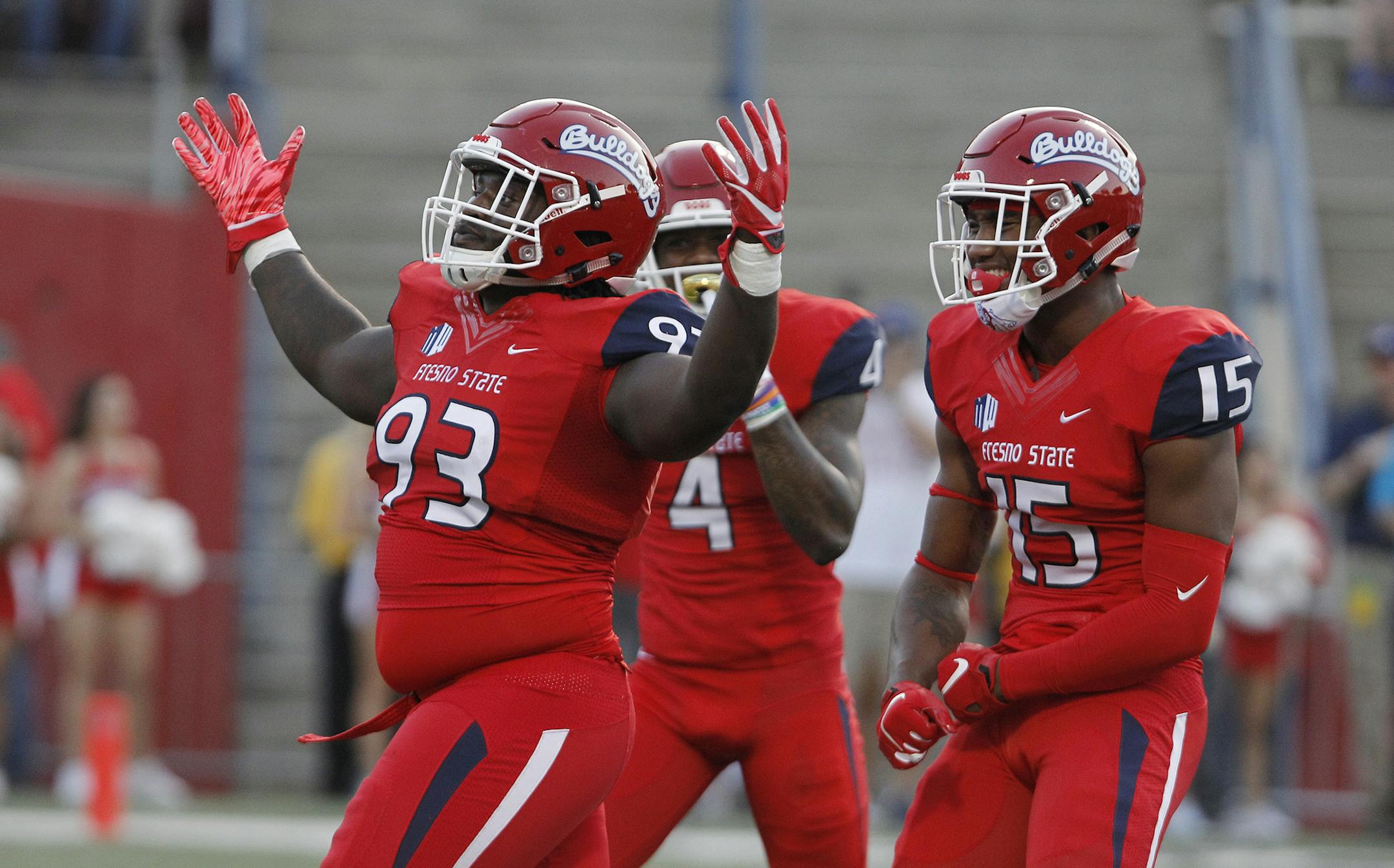 From left to right, Fresno State's Jasad Haynes, Mike Bell and Aaron Mosby celebrate a fumble against Idaho during the first half of an NCAA college football game in Fresno, Calif., Saturday, Sept. 1, 2018. (AP Photo/Gary Kazanjian)