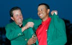 Phil Mickelson helped Tigers Woods put on the Green Jacket after Woods' victory at the Masters in 2005.