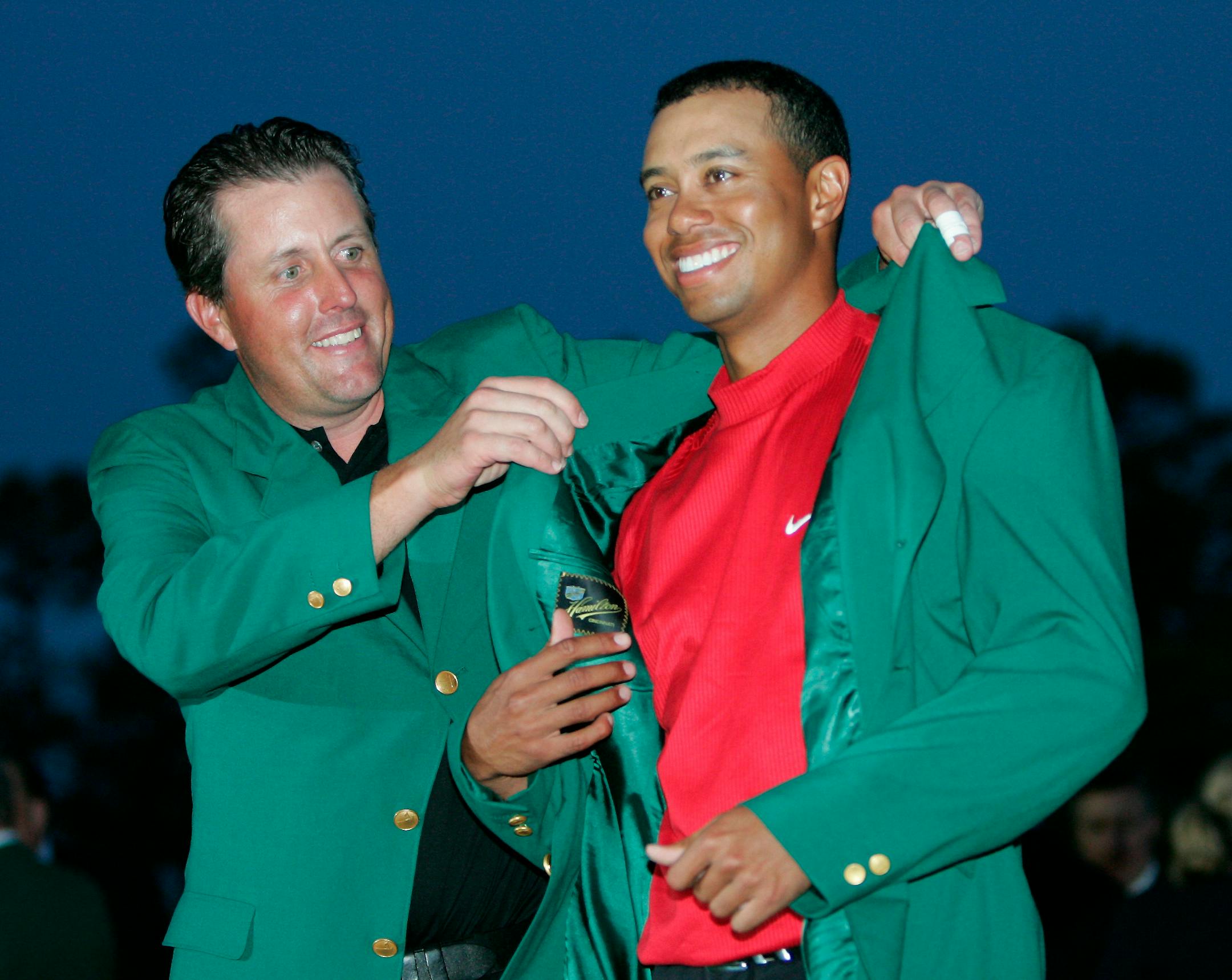 Phil Mickelson helped Tigers Woods put on the Green Jacket after Woods' victory at the Masters in 2005.