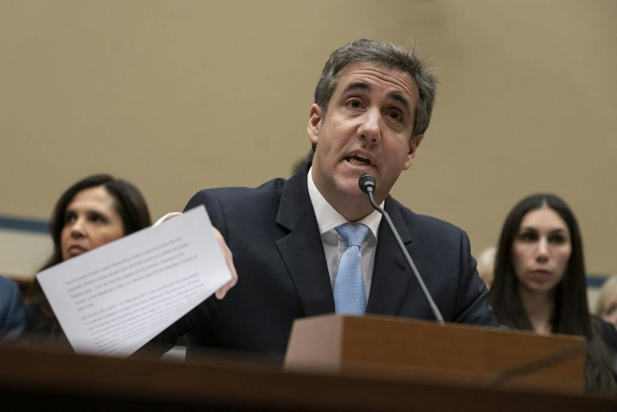 FILE - In this Wednesday, Feb. 27, 2019 file photo, Michael Cohen, President Donald Trump's former personal lawyer, reads an opening statement as he testifies before the House Oversight and Reform Committee on Capitol Hill in Washington. Cohen says he's cooperating with federal prosecutors in New York and hopes to receive a so-called Rule 35 motion from prosecutors that would reduce the time he is to spend in prison.