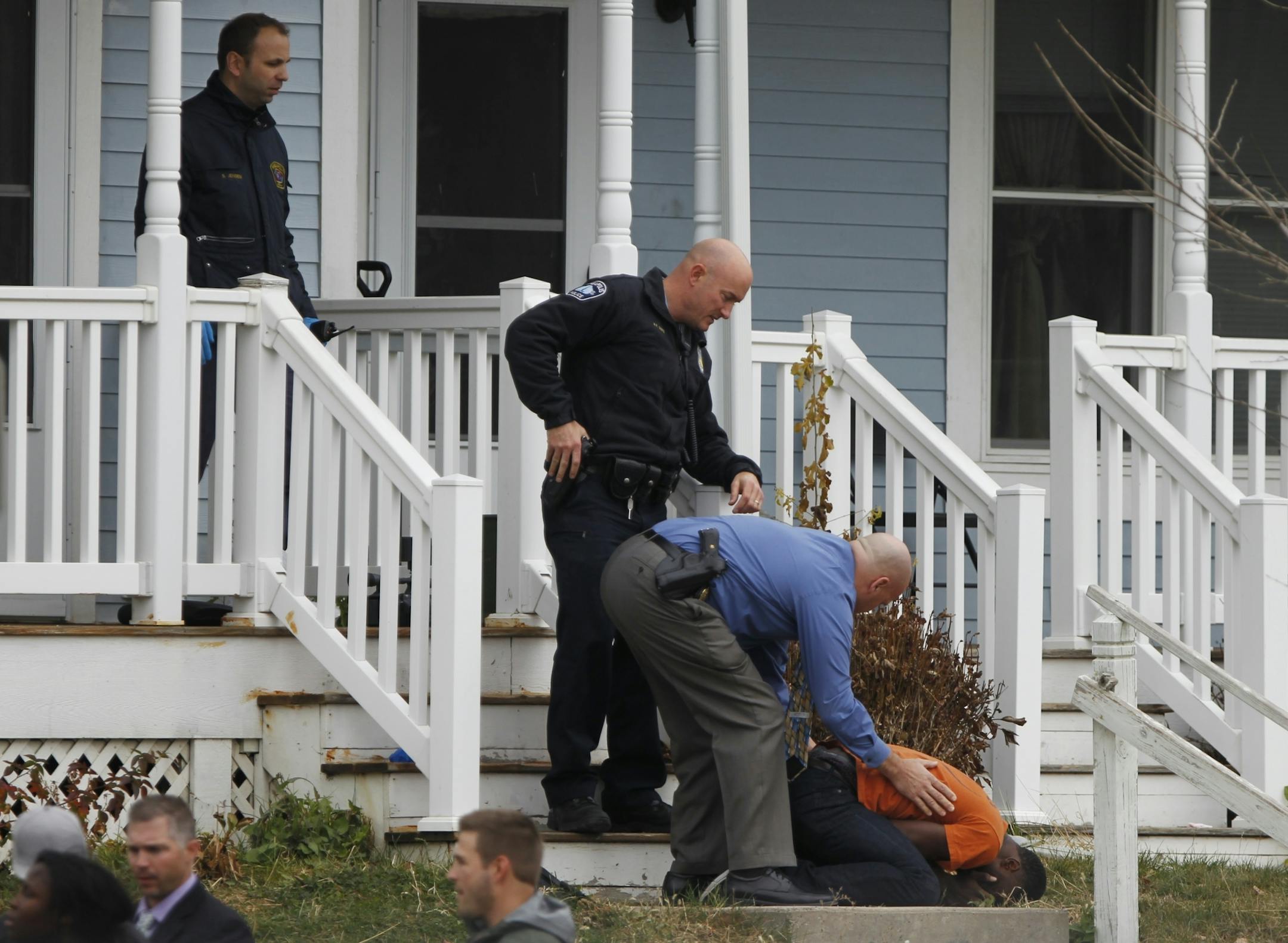 In north Minneapolis, police officers and crime lab personnel restrained and comforted relatives who tried to enter rhe crime scene.